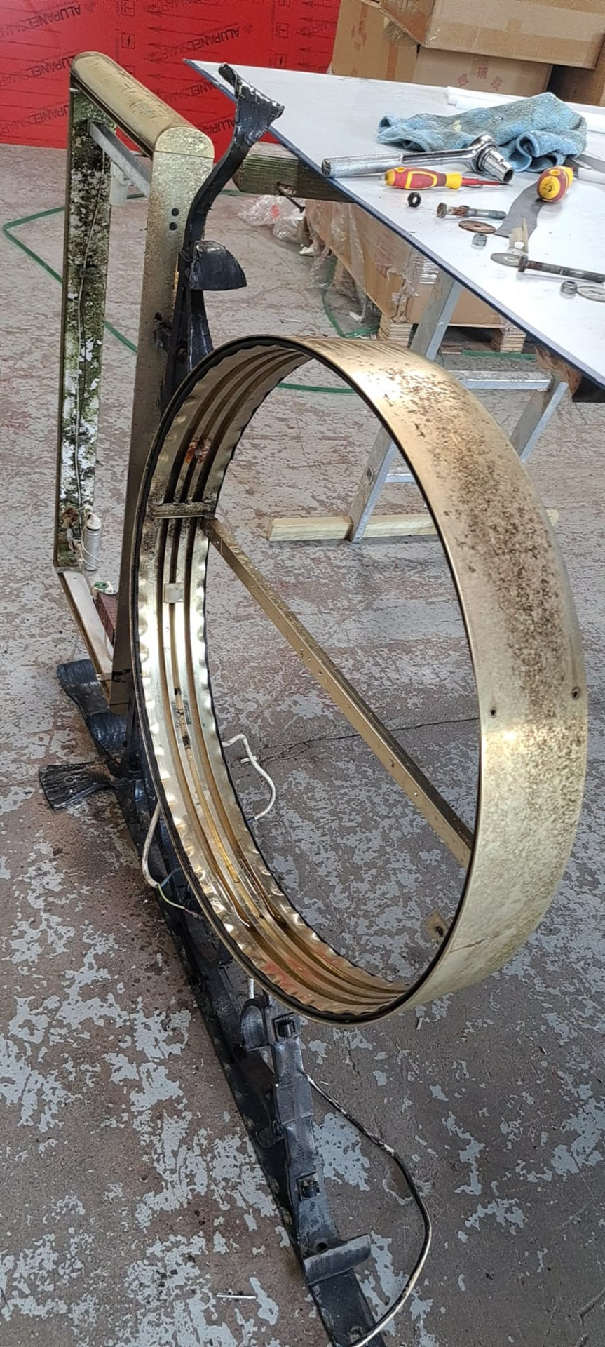 Original brass ring and sign frame removed for restoration in the workshop