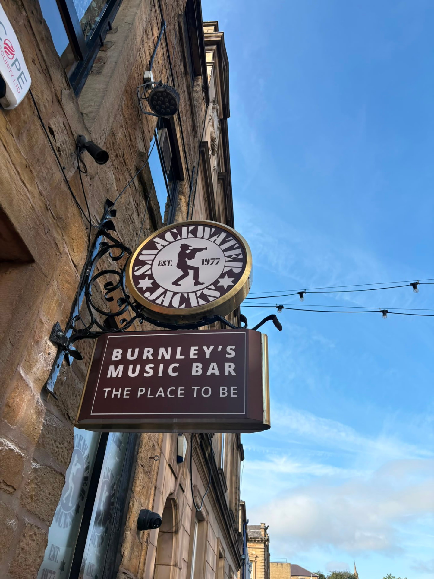 Restored Smackwater Jacks projection sign with brass ring and Burnley's Music Bar lightbox