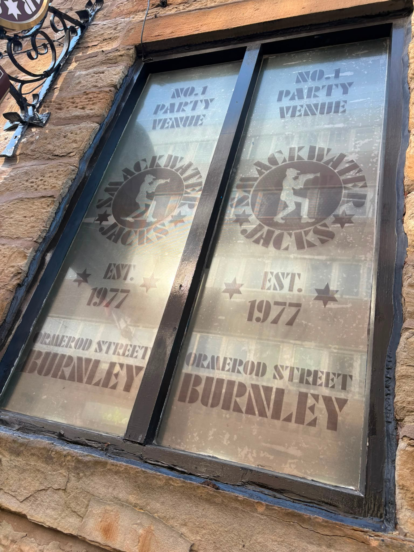 Window contravision graphics reading No.1 Party Venue, Smackwater Jacks, Est. 1977