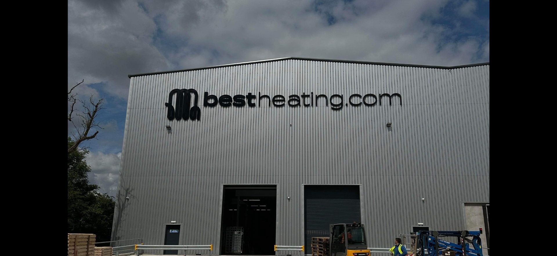 Large bestheating.com built-up letters mounted high on the cladding of a 100,000 sq ft industrial logistics unit in Nelson