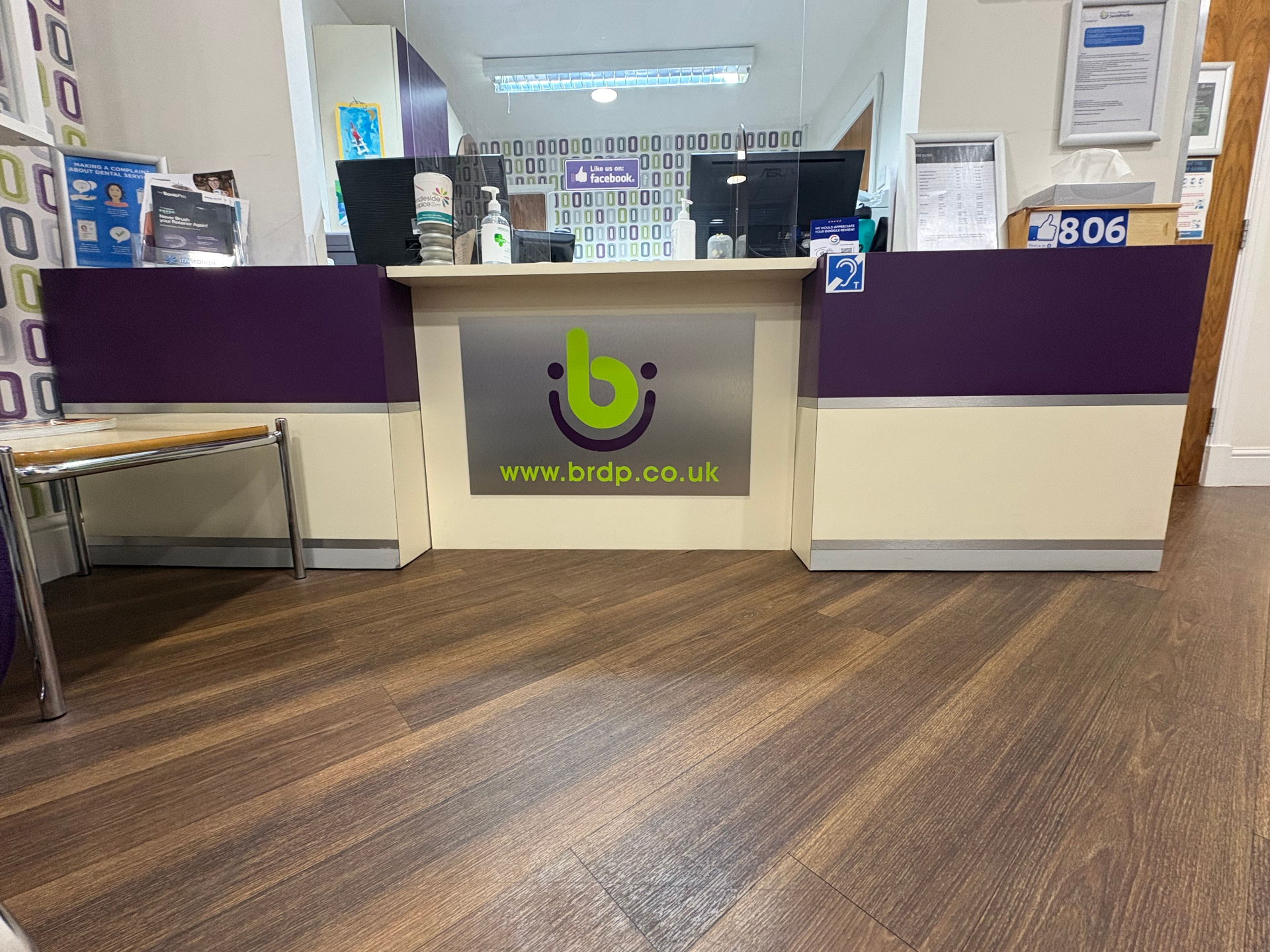 Refurbished reception counter with purple panel wrap, silver trim and printed BRDP logo panel