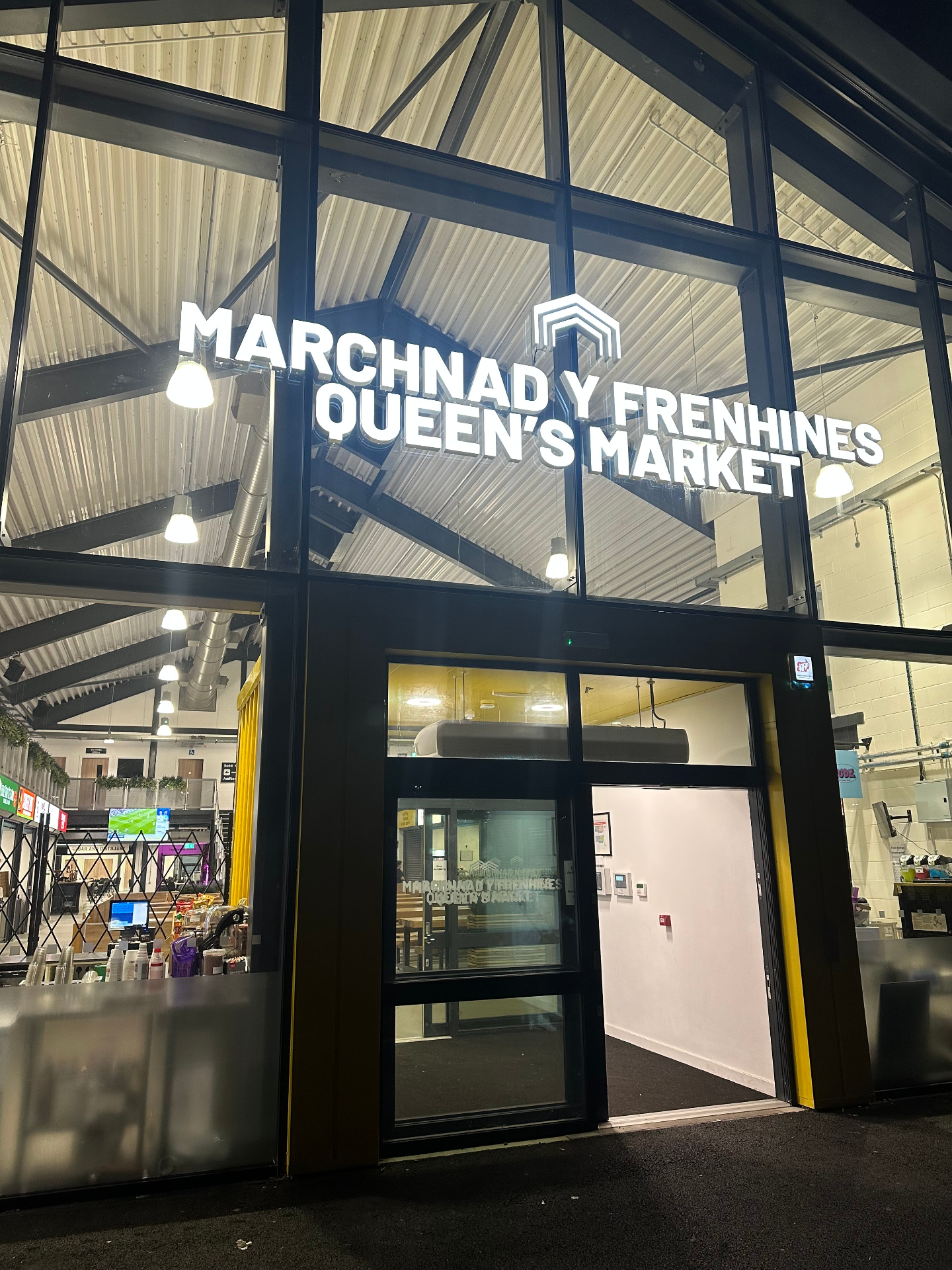 Marchnad y Frenhines / Queen's Market illuminated built-up stainless steel letters on a glass curtain wall elevation in Rhyl