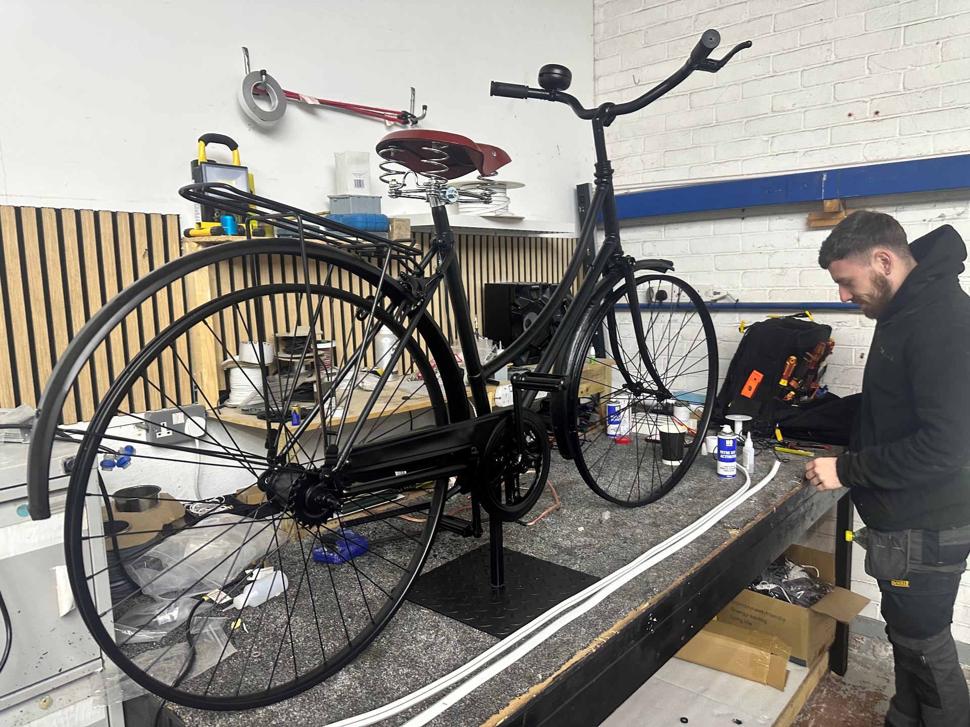 Vintage bicycle being upcycled in the TCB Signage workshop, prepared as an LED feature for the foyer wall wrap