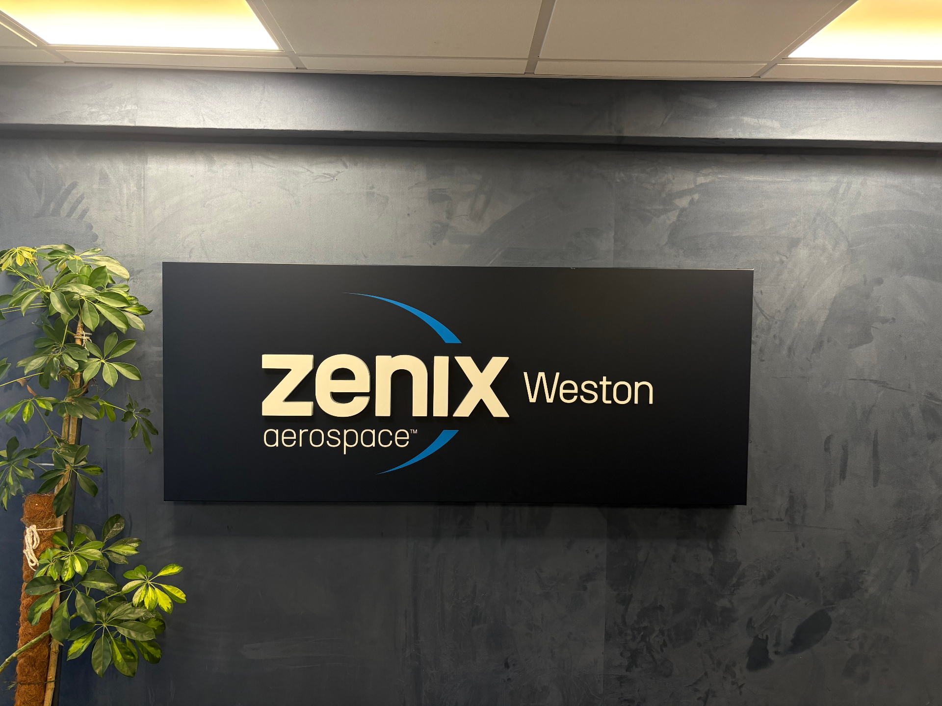 Zenix Aerospace Weston internal lightbox sign with brushed metal lettering